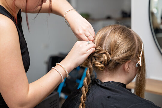 Apprentice hairdresser styling woman long hair, formal occasion wedding bridal prom engagement graduation upstyle hairstyle, coil bun elegant chignon,   beauty salon parlor parlour, apprenticeship