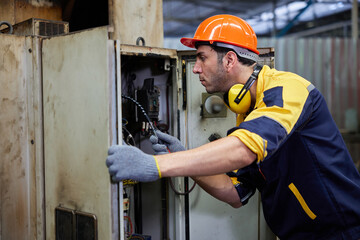 engineer or technician operating industrial control panel in the factory