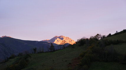 Landscape with a sunlit peak at sunset.