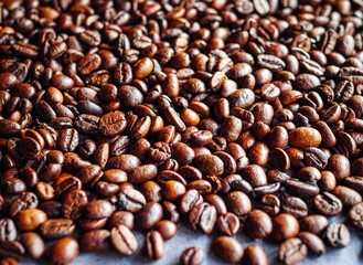 Close up of backdrop dark brown coffee beans and Textured background of freshly roasted coffee beans