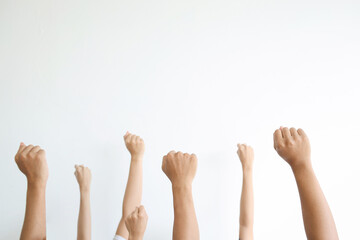 Group of people raised fists up as a victory and success symbol isolated on white background