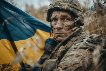 Obraz premium Generative AI illustration of serious young male soldier in protective uniform and ukrainian flag