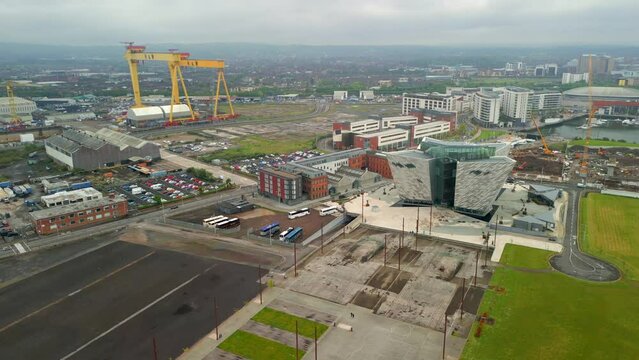 Aerial of Titanic Belfast, Northern Ireland on a moody day.

The camera moves left to right, showing the Dry Docks and Harland and Woolf cranes.

Filmed in 4K, 60fps and in Rec709 color space.