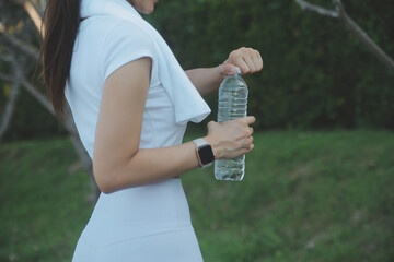 Young woman drinking protein shake outdoors