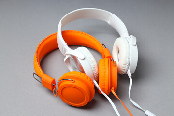 A pair of over-the-ear headphones on a light background.