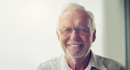 Portrait, home and senior man with glasses, smile and happiness with confidence, peace and relax....
