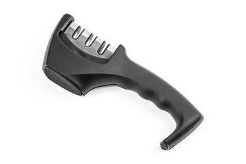 knife with sharpener on the table. Knife and knife sharpener on a white surface. Kitchen tools isolated on white background. Reversible manual knife sharpener.	
