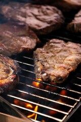 Delicious selection of steak grilling over hot coals in an outdoor setting, ready to be enjoyed