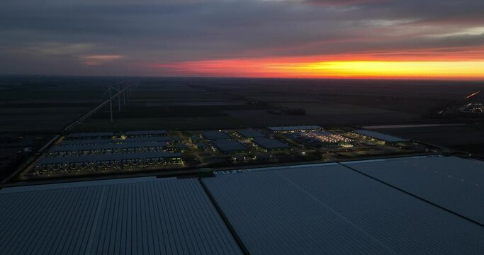 Data center at night in Hollandse Kroon, Middenmeer, The Netherlands at night. Cloud computing and internet infrastructure. Aerial drone view.