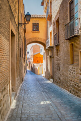 Spain Travel Ideas. Summer Streets of Toledo City in Spain Alleyway Towards Toledo Cathedral Alcazar in The Afternoon.