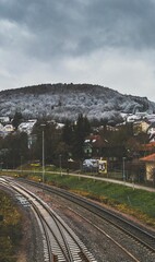 the train tracks near the station and houses are running on them