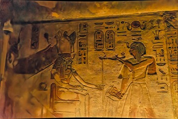 Beautiful, vintage Egyptian images and ancient hieroglyphs engraved in stone inside the temple
