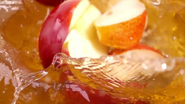 close up of natural apple, pears quarters falling in juice, advertising of fruit juice splashing, super slow motion