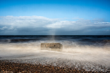 Battered by the Waves. Pill box on the coast at Kingston on Spey slowly slipping into the Cromarty firth