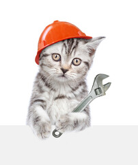 Cute kitten wearing hardhat holding adjustable wrench and looking above blank white banner....