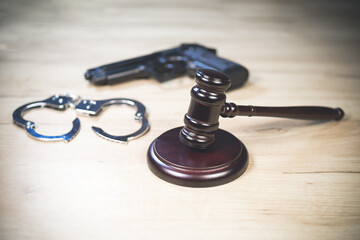 Judge Hammer for adjudication with handcuff and gun. Auction or Lawyer decision. Law and justice...