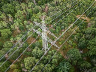 an overhead view of high voltage power lines, with trees in the background