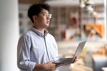 person using laptop in library