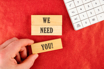 We Need You Message Concept text is made up of wooden blocks on a red background