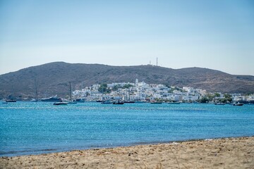 Scenic view of a beach with a body of water and a mountain range in the background