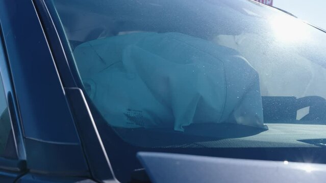 Airbags deployed in an automobile after a head on collision from icy roads on a sunny winter day