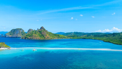 Aerail view of  tropical exotic island sand bar separating sea in two with turquoise  in El Nido, Palawan, Philippines.