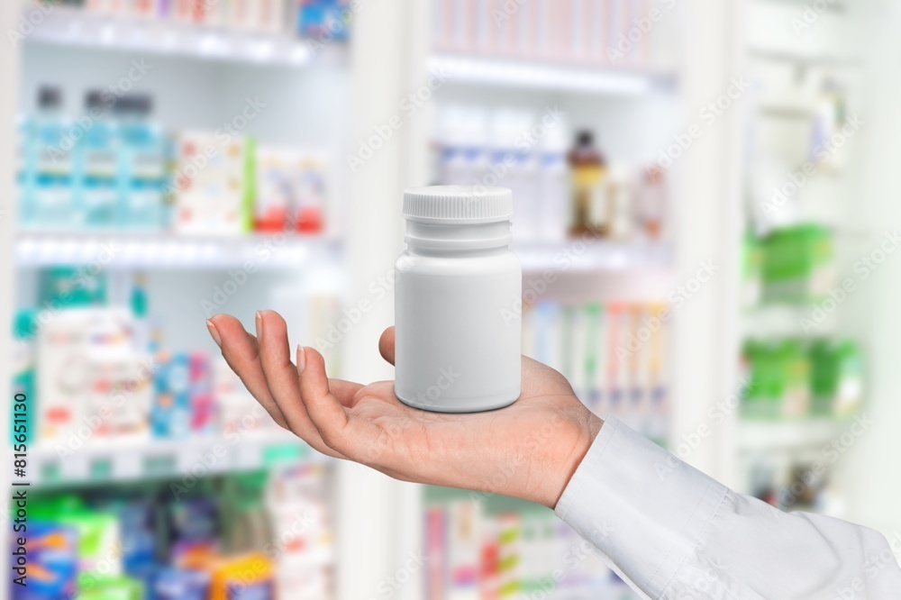 Poster Plastic bottle in hand. Packaging of vitamins or supplement