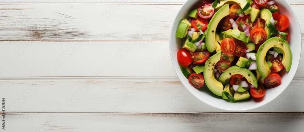 Poster fresh avocado tomato salad in a bowl on a white wooden background top view flat lay overhead from ab