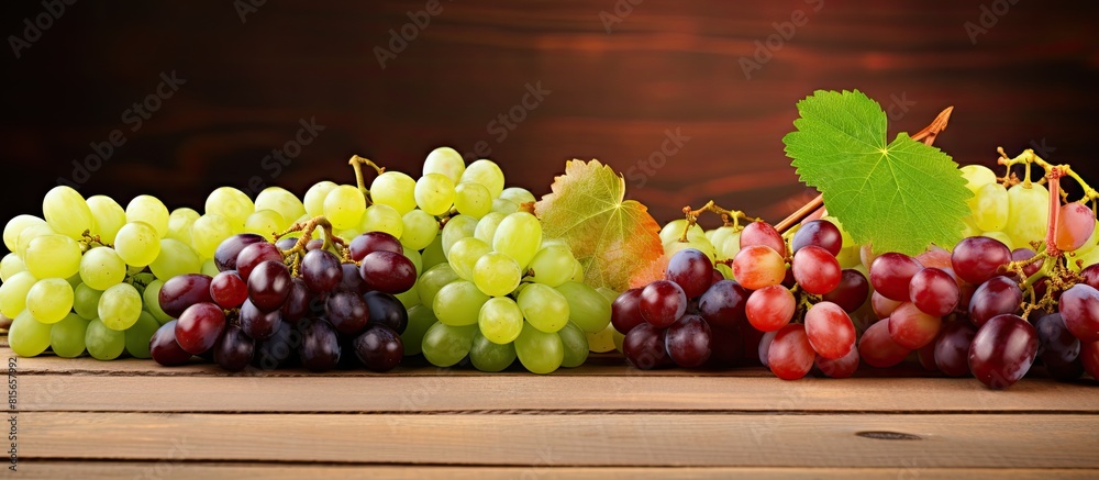 Aufkleber different fresh ripe juicy grapes and space for text on wooden table top view. copy space available