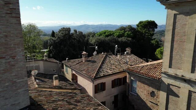 Drone shot of old buildings in Novilara hamlet on a sunny day in Pesaro and Urbino province, Italy