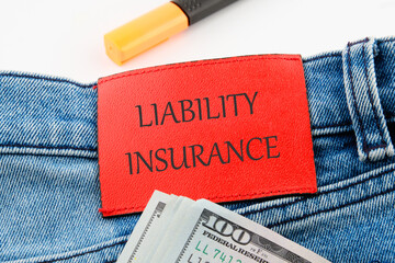 Text Liability Insurance on the leather insert of jeans with dollar bills sticking out