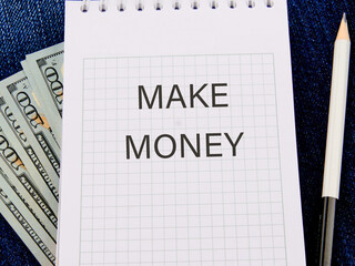 Business concept , business idea,business analysis. MAKE MONEY on a notepad against the background of money