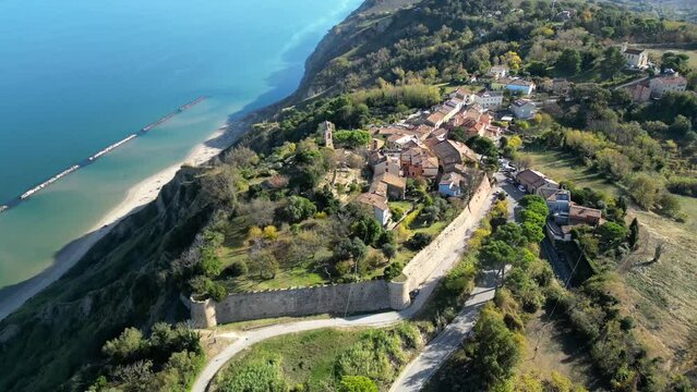 Aerial footage of the village of Fiorenzuola di Focara on the Mediterranean coast in Pesaro, Italy