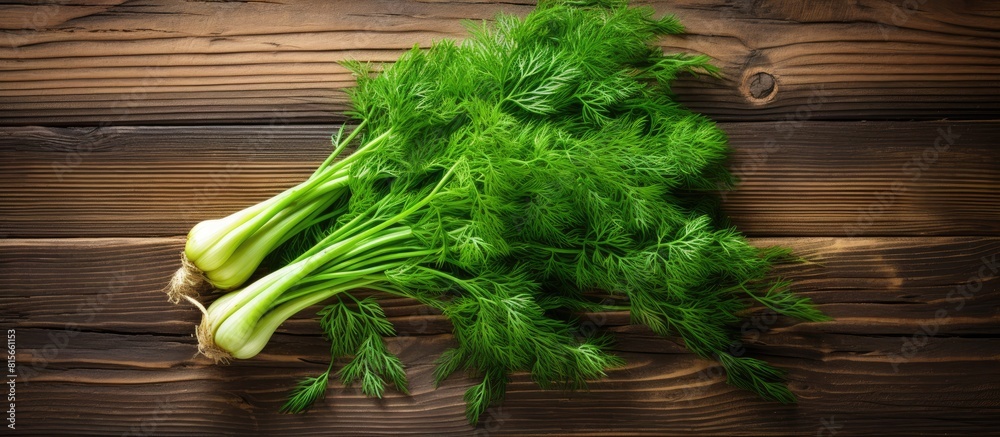 Poster a bunch of green dill on a wooden background with blank space for text concept of fresh vegetables a