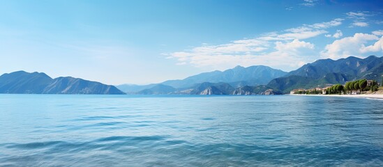 Fototapeta premium sea bay with mountains on background and blue sky copy space