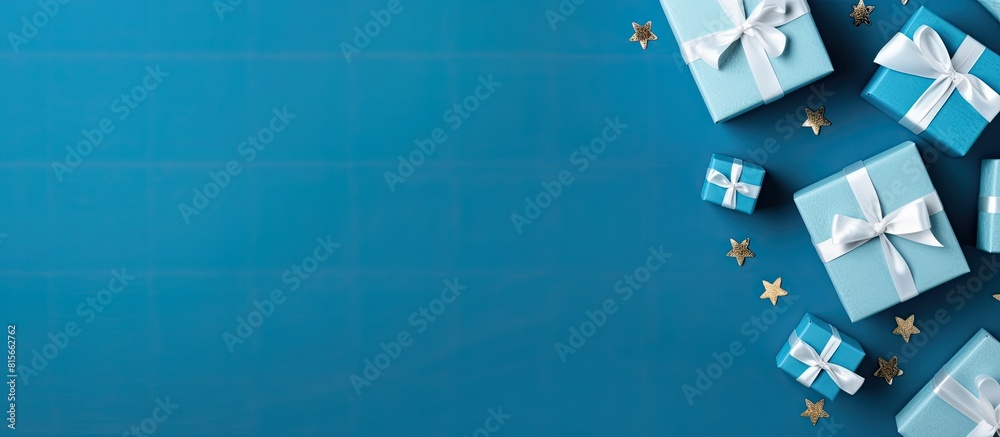 Poster flat lay composition with gift boxes on blue background space for text greeting card. copy space ava