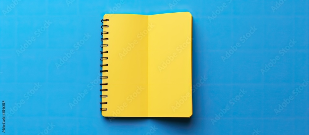 Aufkleber flat lay design with blank on note book yellow and blue background. copy space available