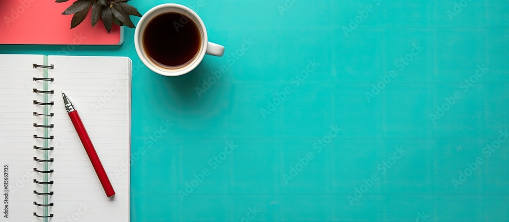 Aufkleber Top view of a modern workplace with a notebook or laptop a coffee cup and a diary book on a colorful background providing copy space for images The style is flat lay