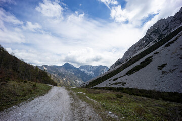 Begunjščica panorama of mountain trekking to the highest peak. View of the Alps, climbing with via ferrata. Distant view of Lake Bled from above. Sports holidays, life of adventure in the countryside.