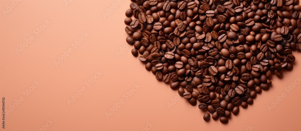 Poster top view of a light orange background featuring a heart shaped pile of coffee beans providing ample 