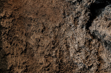 Black soot background in bright light. The inside of a clogged chimney pipe. Macro shot. Texture of...