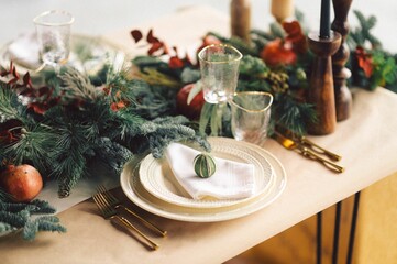 Festive and elegant Christmas dinner setting with ornate golden-plated silverware