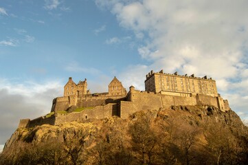 Picturesque view of an ancient castle situated on a hilltop surrounded by lush trees