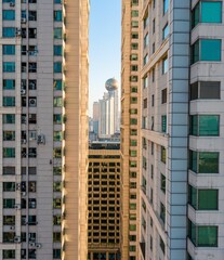 The two residential buildings, a skyscraper in the distance