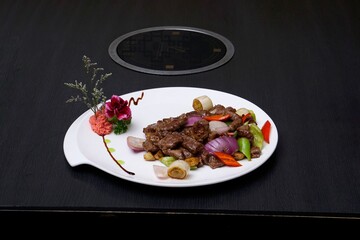 Juicy steak served on a white plate with freshly cooked vegetables