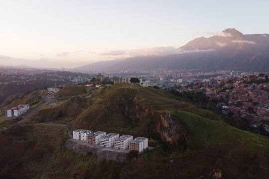 Aerial view of Caracas at sunset with the Petare neighborhood, the largest slum in Venezuela and latin america, with the Avila Mountain in the background.