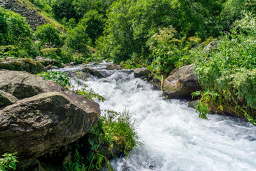 Stream between large rocks of a mountain river in a gorge. Tsalka canyon, Georgia