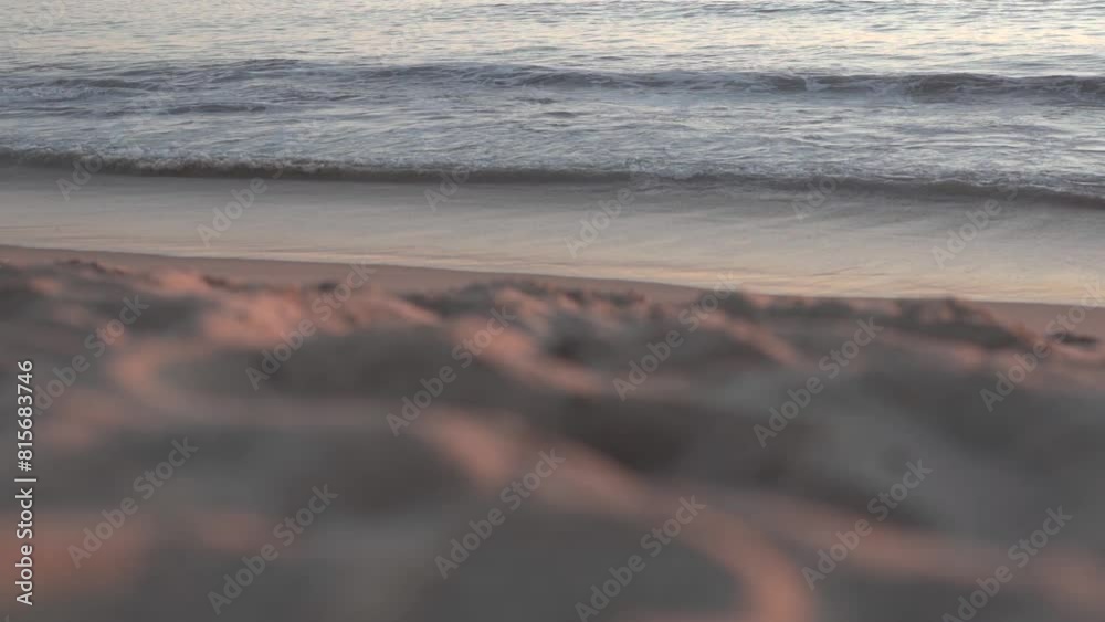 Wall mural Slow motion of the ocean waves on Newport beach with sand dune in the blur foreground at sunset, USA