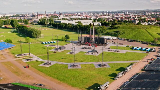 Aerial flight over the concert area of German band Rammstein in Dresden with a beautiful view over the city. Drone move forward