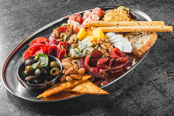 A gourmet platter featuring an assortment of cheeses, fruits, nuts, and meats, elegantly arranged...